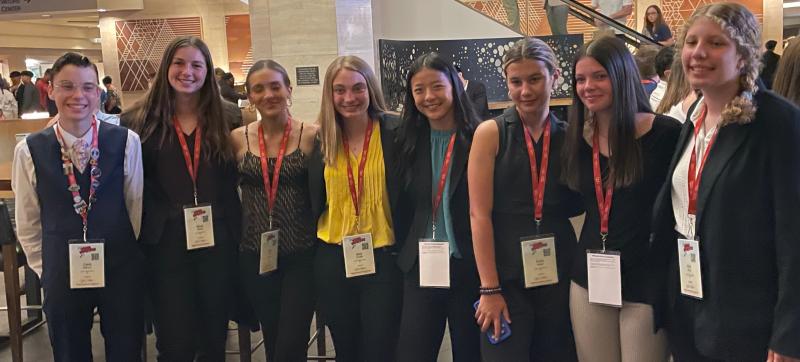 After a non-stop six hour flight, the Mariner BPA team awaits the start of the opening ceremony and official kick-off of the 2023 National Leadership Conference. Gathered are (l-r) Caleb Marcus, Elena Booth, Macy Davis, Blair, Chubb, Kate Dowd, Emily Wells, Kate Hill and Ariel King.